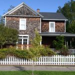 Front view of house with white picket fence