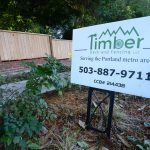 Timber sign in front of new fencing